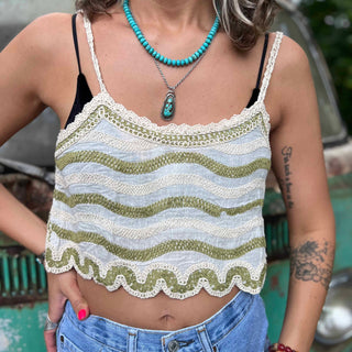 Open crochet lace front of boho crop tank top in ivory – model showing breathable fabric design with hand on lower back 