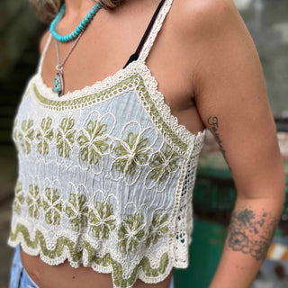 side view of white linen tank top with green flowers 