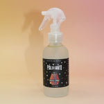 Palo Santo smoke spray bottle with a label on a gradient background