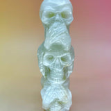 Front view of skulls covering eyes, ears, and mouth (see/hear/speak no evil)