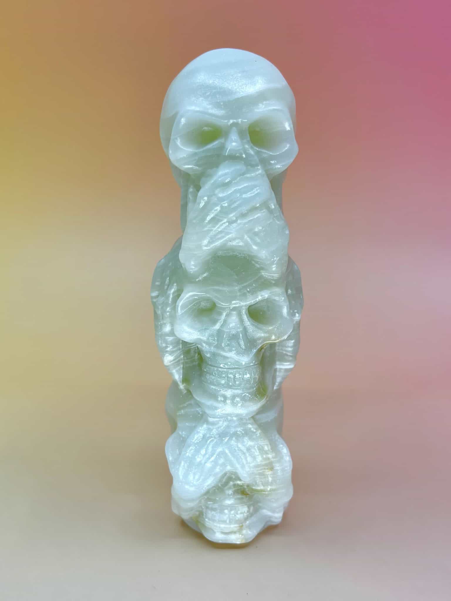 Front view of skulls covering eyes, ears, and mouth (see/hear/speak no evil)