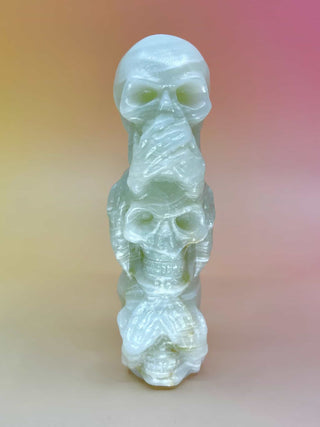 Front view of skulls covering eyes, ears, and mouth (see/hear/speak no evil)