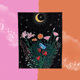 The Nighttime Bouquet Flower Moon Tapestry on a pink and orange background.