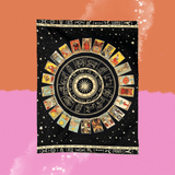 The Mystical Zodiac Wheel & Tarot Card Tapestry on a pink and orange background.