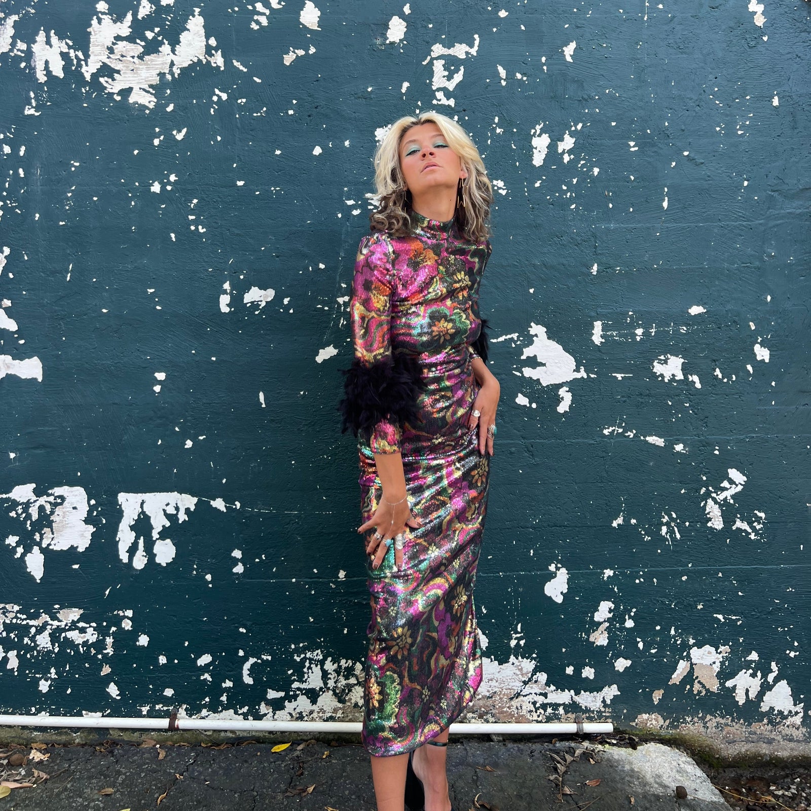 Person lying on a textured surface with peeling paint