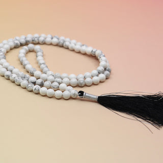 Howlite 108 Mala Necklace on orange and pink background