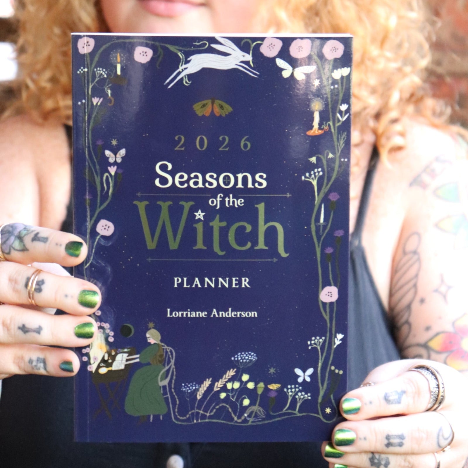 Someone holding the 2026 Seasons of the Witch Planner Calendar.