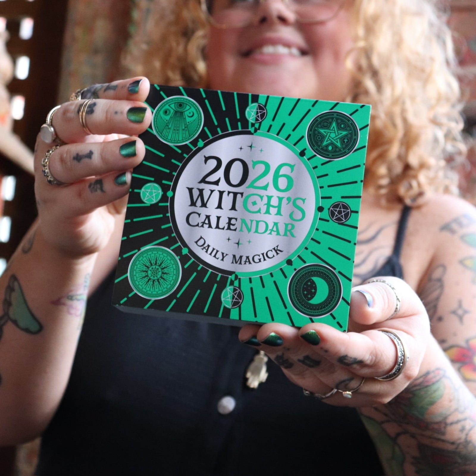 Someone holding the 2026 Witch's Calendar Daily Magick Day-to-Day Calendar.