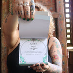 Someone holding the 2026 Witch's Calendar Daily Magick Day-to-Day Calendar, showing off the pages, showing off the pages.