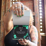 Someone holding the 2026 Witch's Calendar Daily Magick Day-to-Day Calendar, showing off the pages, showing off the pages.