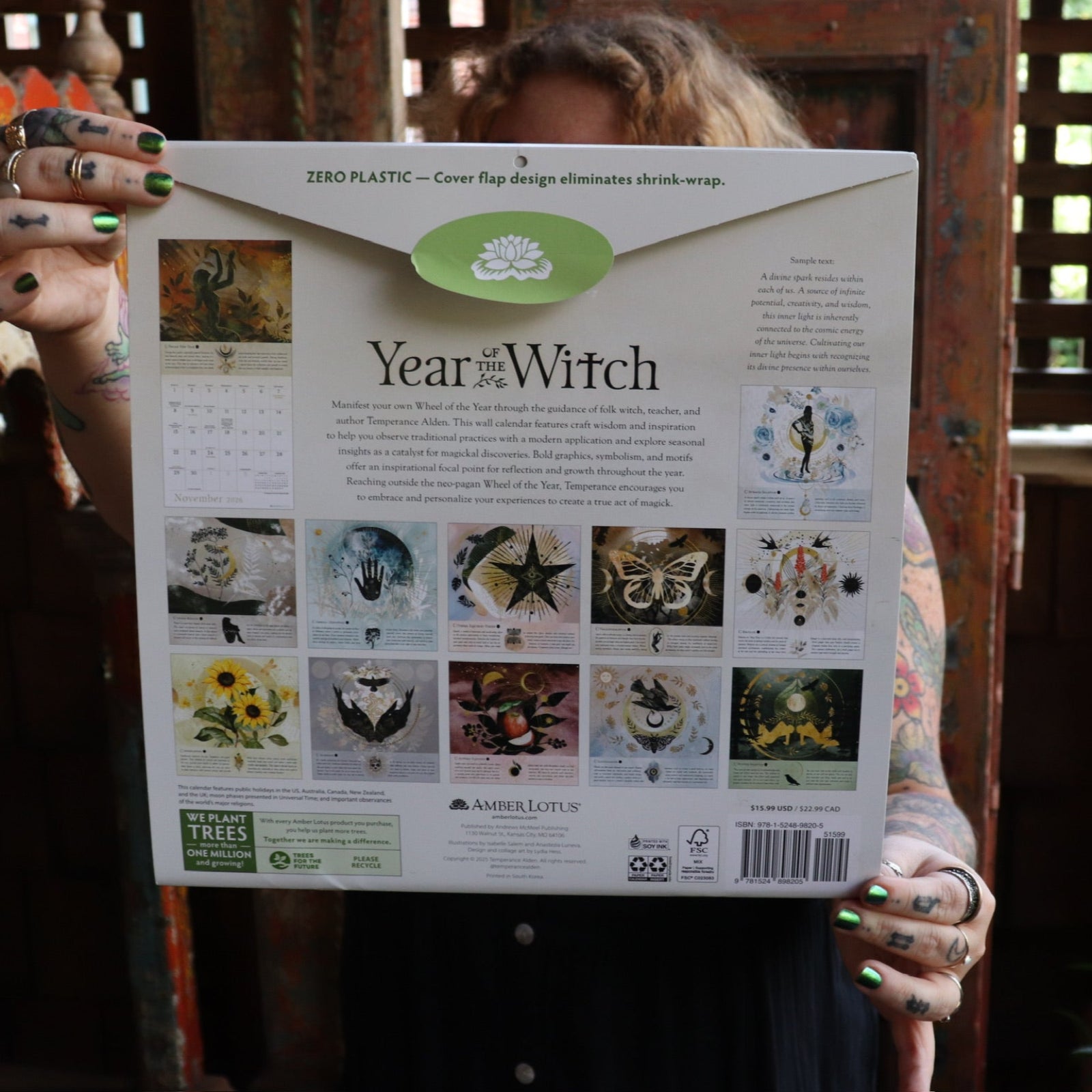 Someone holding up the Year of the Witch 2026 Wall Calendar, showing off the back