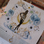 Someone holding up the Year of the Witch 2026 Wall Calendar, showing off the pages.