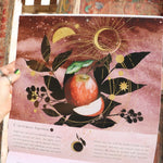 Someone holding up the Year of the Witch 2026 Wall Calendar, showing off the pages.