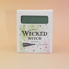 The Wicked Witch Wicked Themed 4 oz Bar Natural Soap on a pink and yellow background.