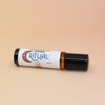 The Ritual 10ml Roll-On Perfume Oil on a pink and yellow background.