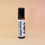 The Hippie Witch 10ml Roll-On Perfume Oil on a pink and yellow background.