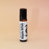 The Hippie Witch 10ml Roll-On Perfume Oil on a pink and yellow background.