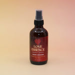 The Love Essence Organic Crystal Charged Energy Spray on a pink and yellow background.