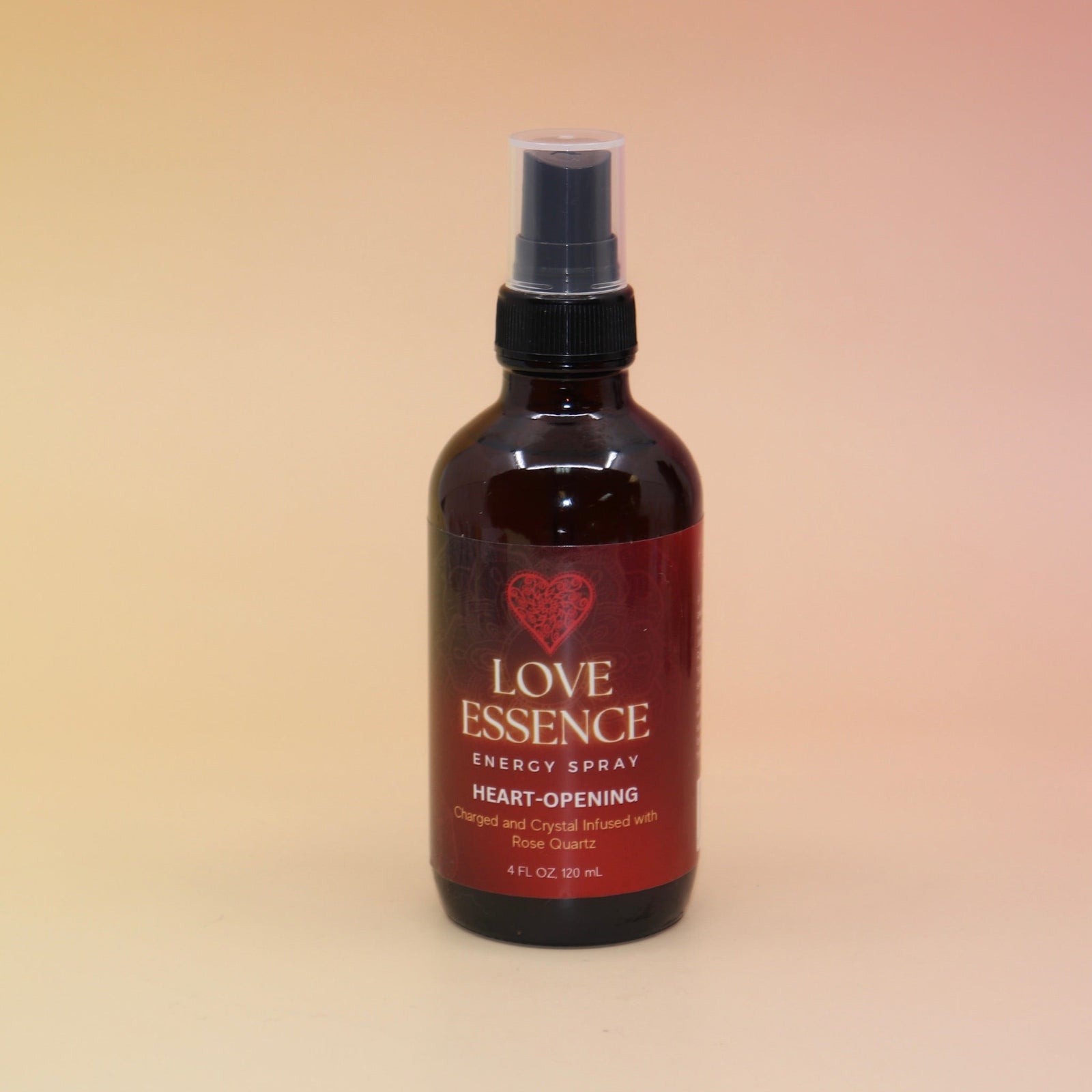 The Love Essence Organic Crystal Charged Energy Spray on a pink and yellow background.