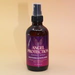 The Angel Protection Organic Crystal Charged Energy Spray on a pink and yellow background.