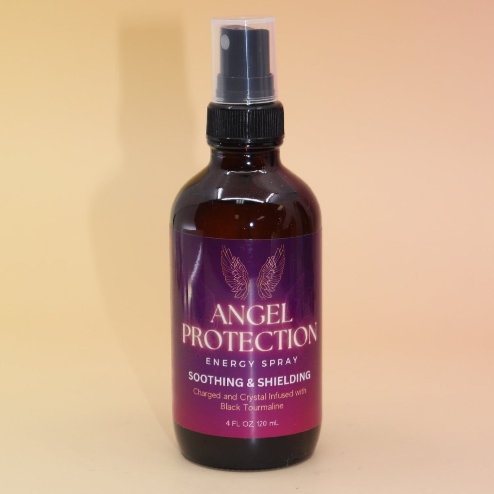 The Angel Protection Organic Crystal Charged Energy Spray on a pink and yellow background.