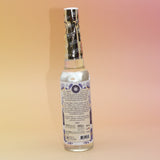 The back of the White Sage Spiritual Cleansing Water 7.5 oz on a pink and yellow background.