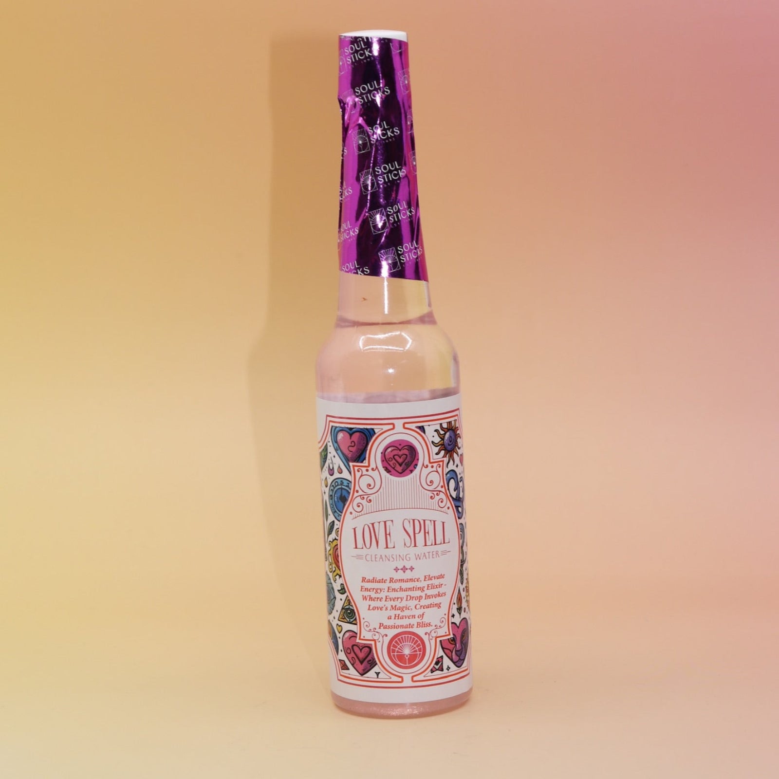 The Love Spell Spiritual Cleansing Water 7.5 oz. on a pink and yellow background.