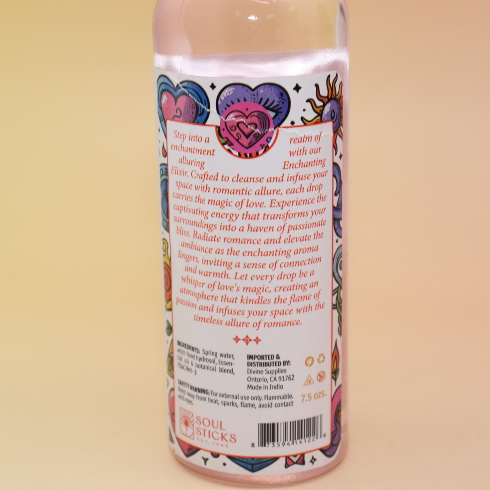 An up-close image of the back of the Love Spell Spiritual Cleansing Water 7.5 oz. on a pink and yellow background.