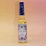 The Healing Energy Cleansing Water 7.5 oz on a pink and yellow background.
