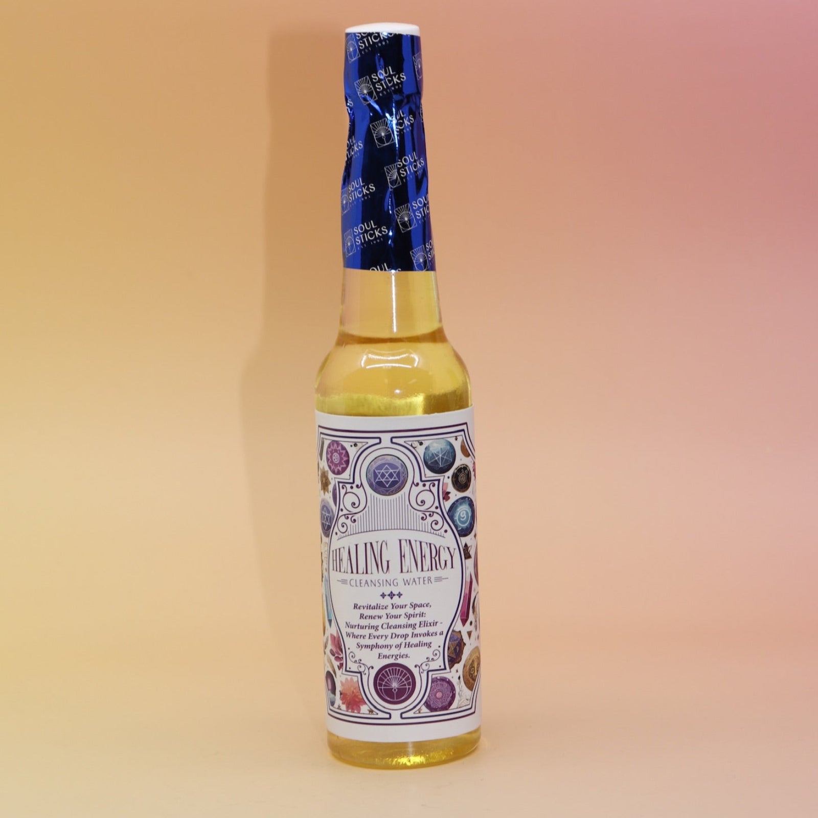 The Healing Energy Cleansing Water 7.5 oz on a pink and yellow background.