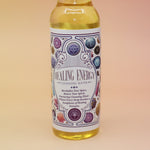 An up-close image of the Healing Energy Cleansing Water 7.5 oz on a pink and yellow background.