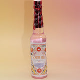 The Positive Vibes Spiritual Cleansing Water 7.5 oz on a pink and yellow background.