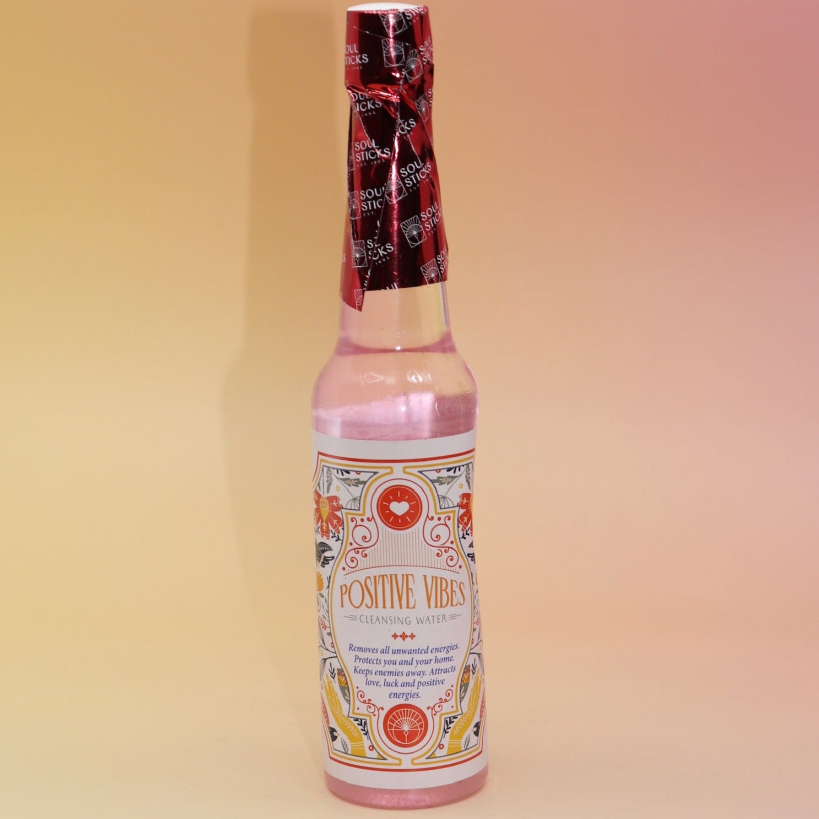 The Positive Vibes Spiritual Cleansing Water 7.5 oz on a pink and yellow background.