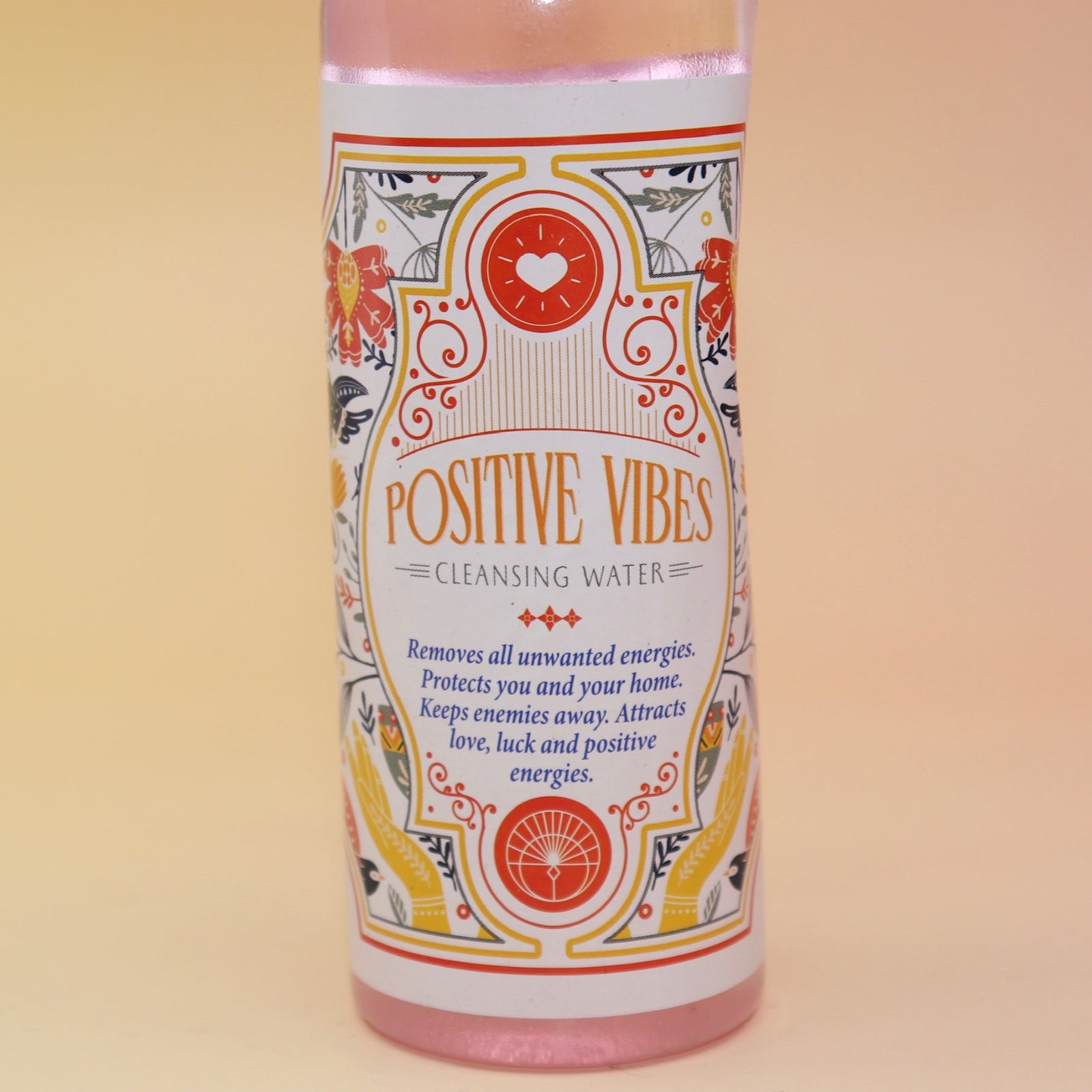 The Positive Vibes Spiritual Cleansing Water 7.5 oz on a pink and yellow background.