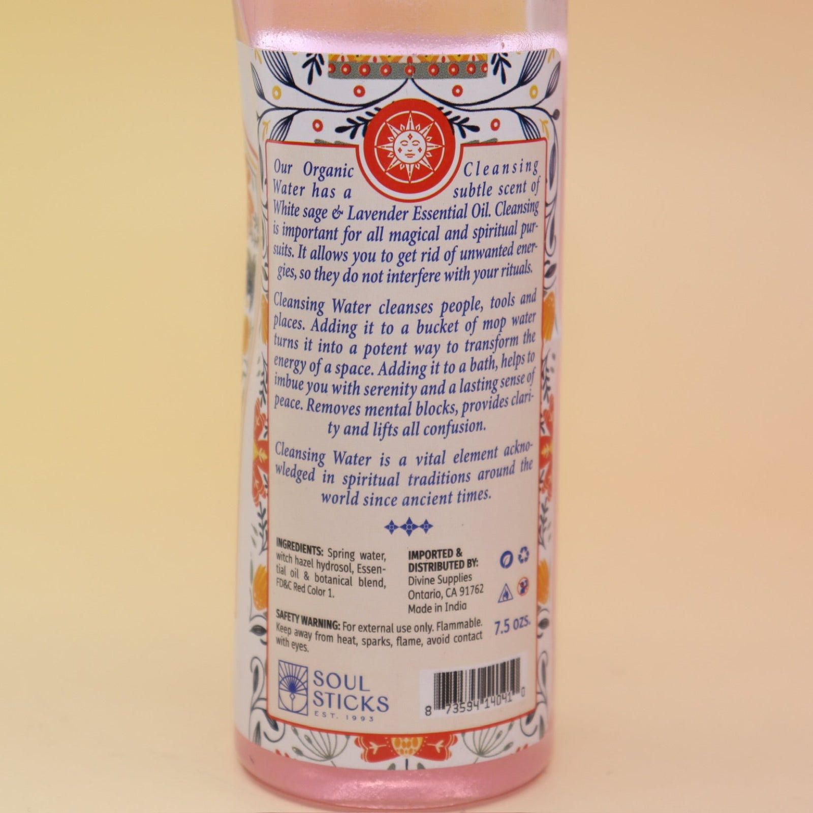 An up-close image of the back of the Positive Vibes Spiritual Cleansing Water 7.5 oz on a pink and yellow background.