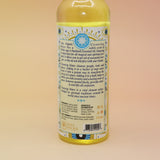 The back of the Go Away Evil Spiritual Cleansing Water 7.5 oz on a pink and yellow background.