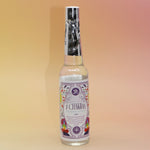 The 7 Chakras Spiritual Cleansing Water 7.5 oz on a pink and yellow background. 