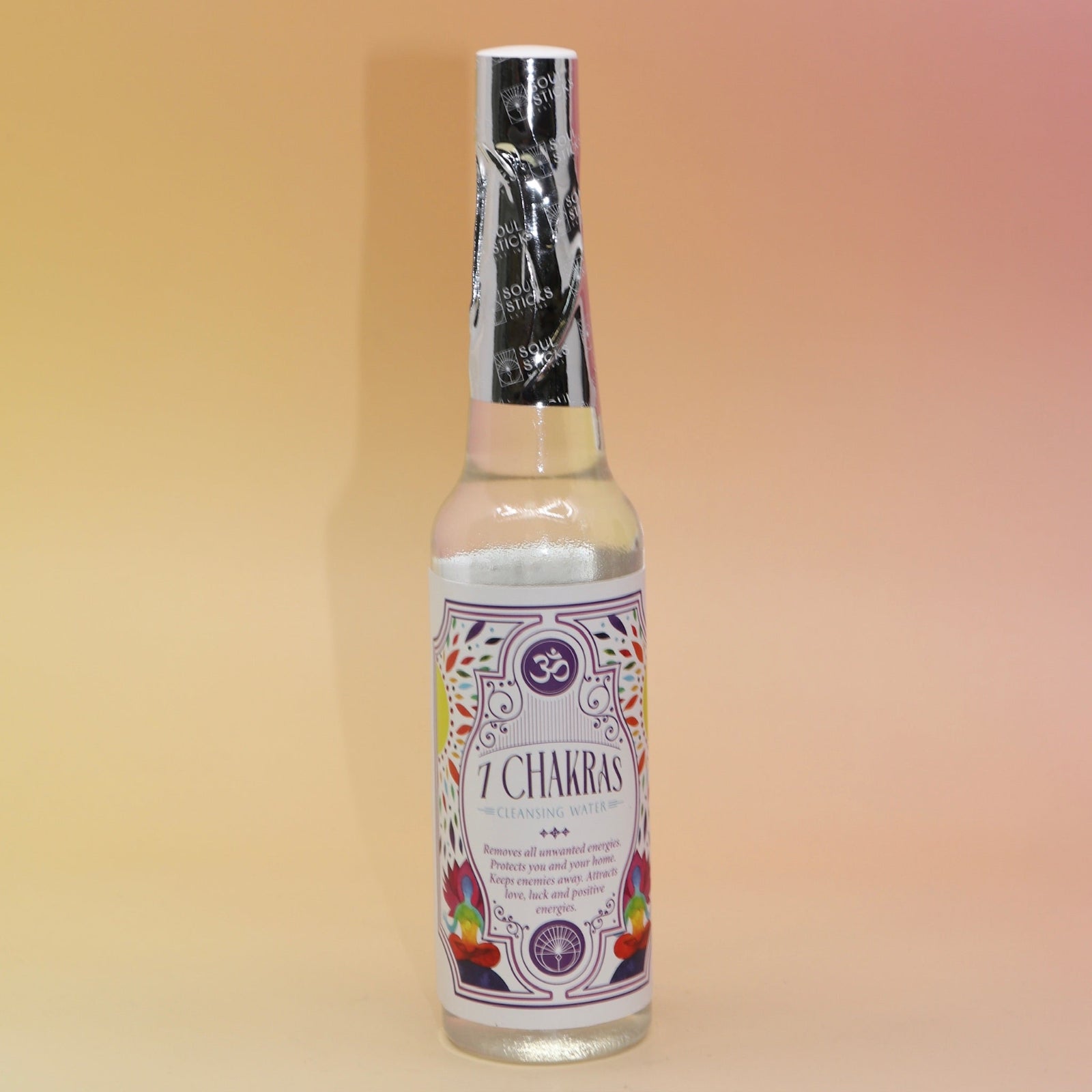 The 7 Chakras Spiritual Cleansing Water 7.5 oz on a pink and yellow background. 