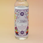 An up-close image of the 7 Chakras Spiritual Cleansing Water 7.5 oz on a pink and yellow background. 