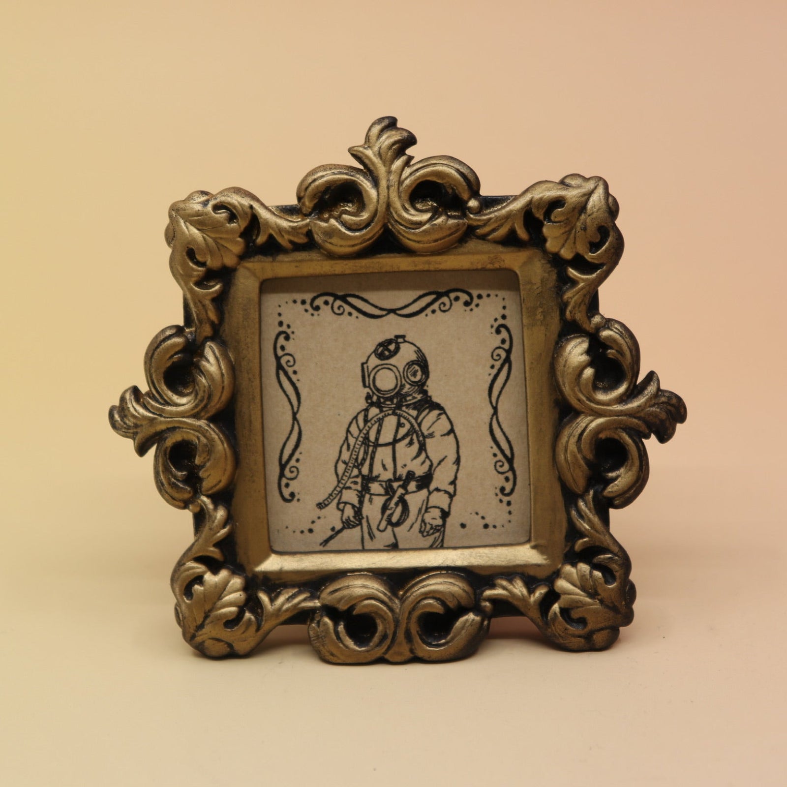 The Deep Sea Diver Mini Vintage Framed Print on a pink and yellow background.