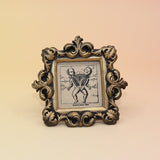 The Conjoined Twin Diagram Mini Vintage Framed Print on a pink and yellow background.