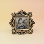 The Frog Mini Vintage Framed Print on a pink and yellow background.