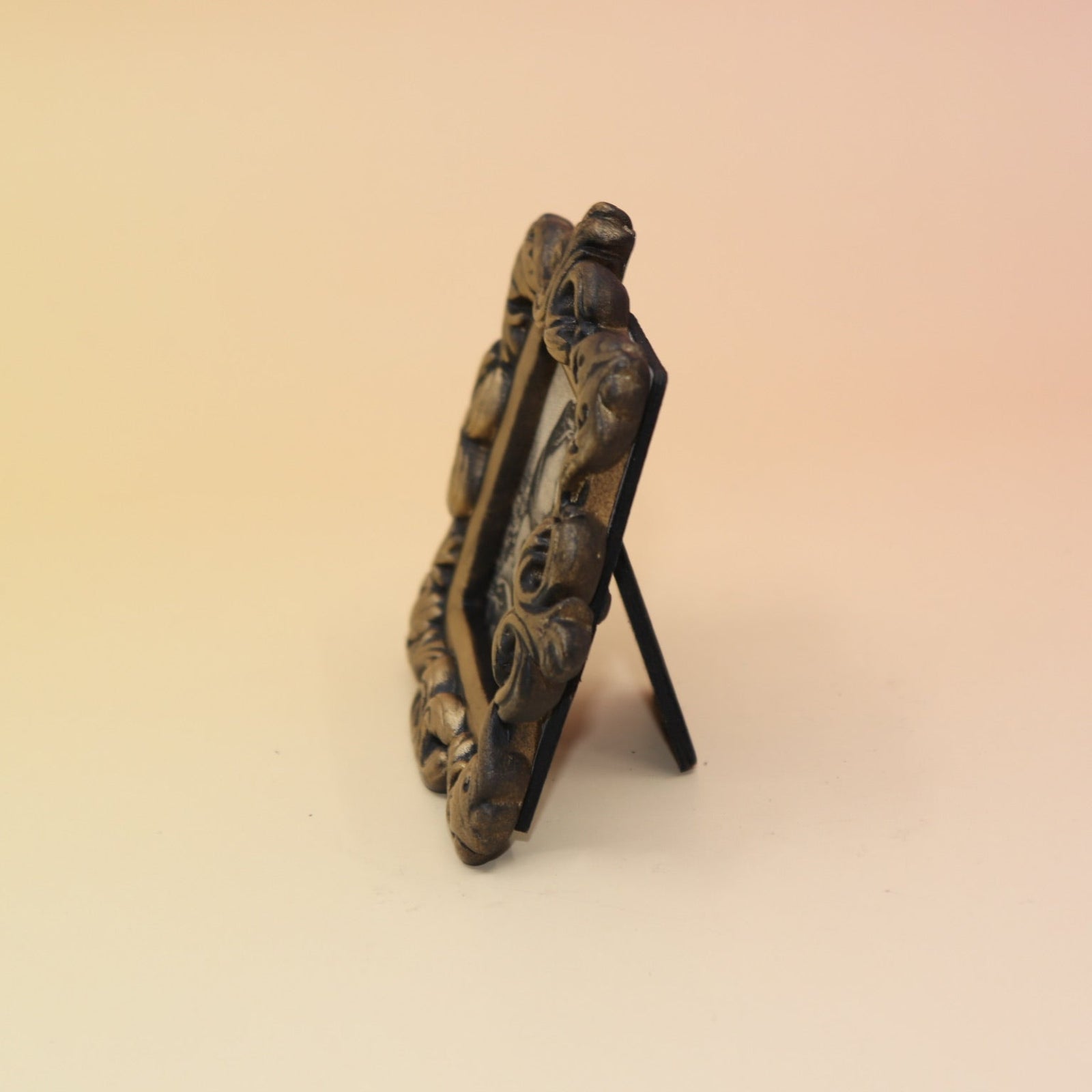 The Frog Mini Vintage Framed Print on a pink and yellow background.