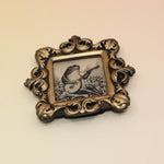 The Frog Mini Vintage Framed Print on a pink and yellow background.