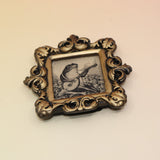 The Frog Mini Vintage Framed Print on a pink and yellow background.