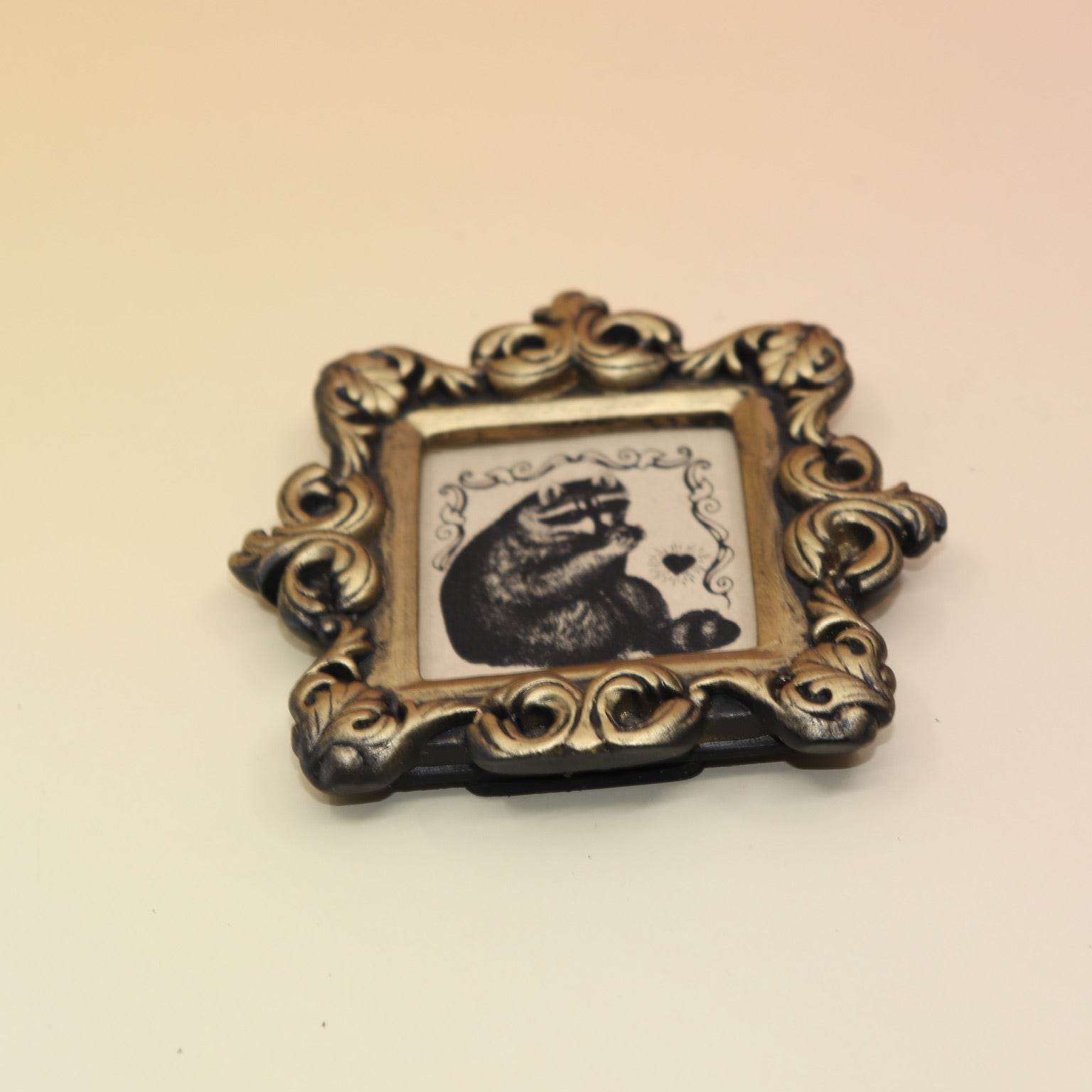 The Raccoon Mini Vintage Framed Print on a pink and yellow background.