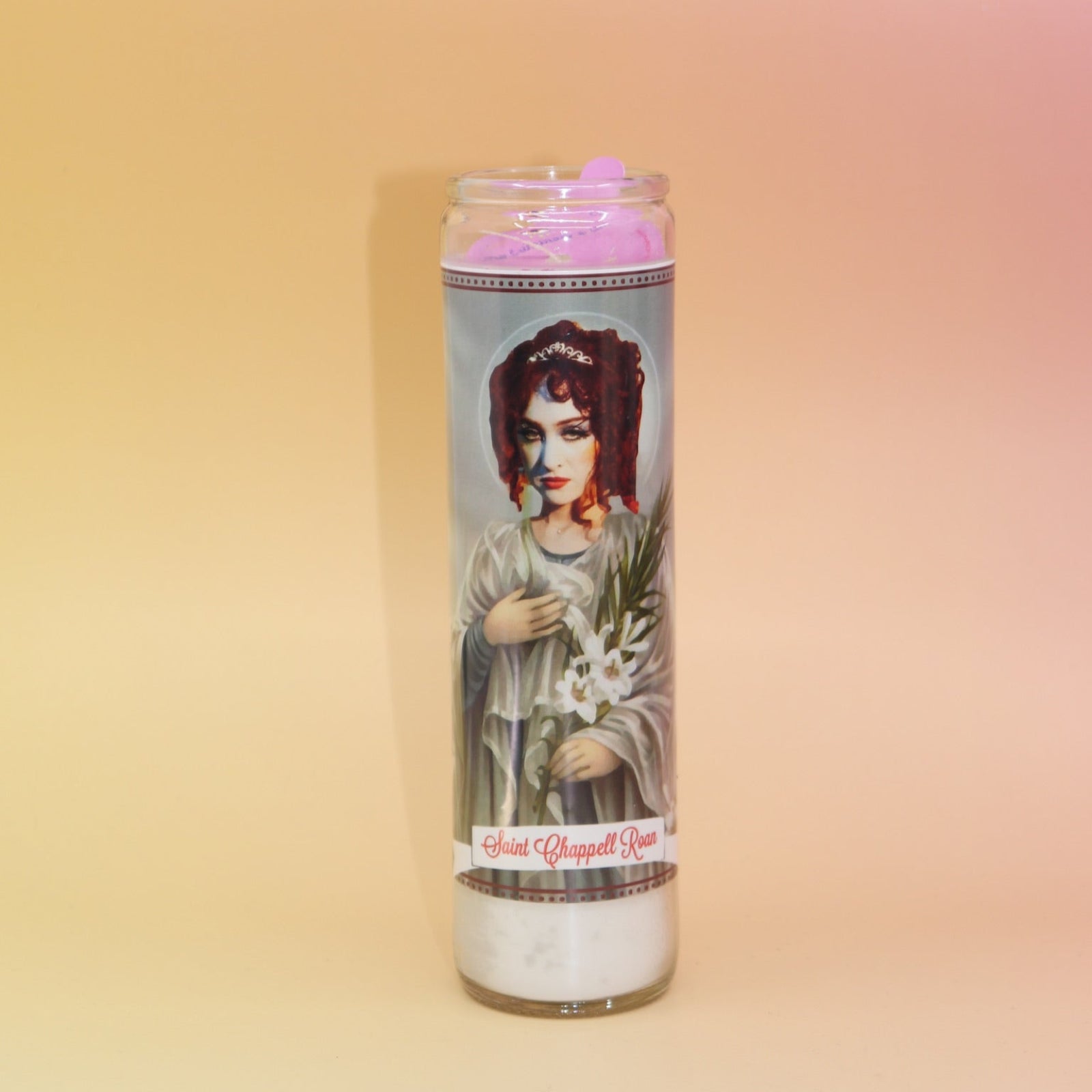 The Saint Chappell Roan Devotional Prayer Candle on a pink and yellow background.