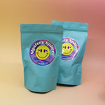 Two of the small - medium Mystery Crystal Sphere Bags on a pink and yellow background.