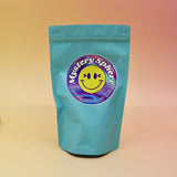 A small - medium Mystery Crystal Sphere Bag on a pink and yellow background.