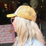 A woman wearing the Not Slim Kinda Shady Trucker Hat in front of a window, showing off the side.